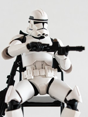 Image of a stormtrooper sitting down while holding a blaster.
